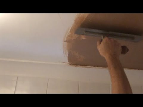 Plastering ceiling patch.