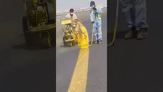 Spray painting of markings on airplane runways
