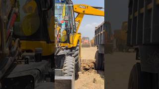 JCB 3DX loading sand in a lorry