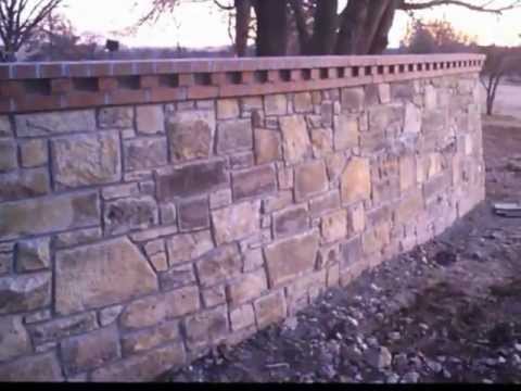 Reclaimed Kansas Limestone Privacy Wall with Brick Cap by Josh Link