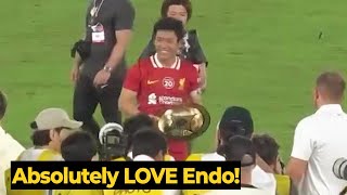 Moment Wataru Endo doing the honours of lifting the J-League World Challenge trophy for Liverpool