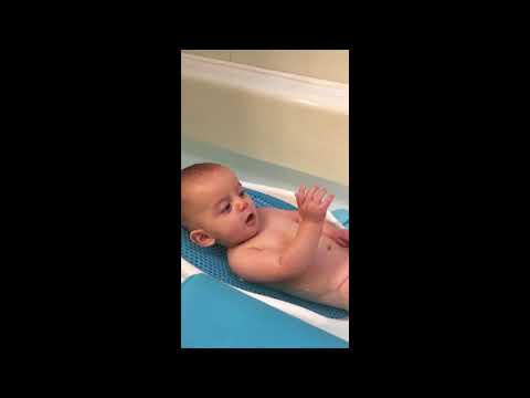 Baby discovers hand in tub