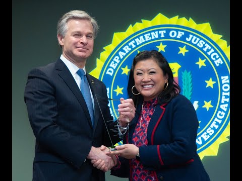 FBI Director Chris Wray awards TVAF's Michelle Li with a Community Leadership Award