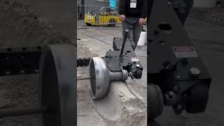 They are testing a wall smoothing tool for sand & cement, making the work easier without using hands