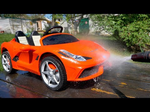 Arthur is playing at the car wash and washing his Ferrari
