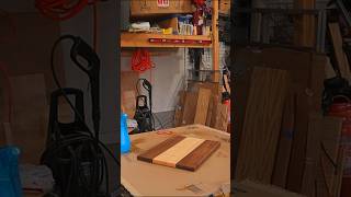 Sanding and raising the grain of the maple and walnut charcuterie board with built in cheese slicer