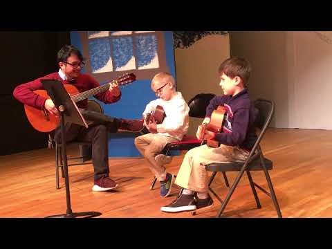 NEMPAC Instructor Chris with young group guitar students 12/01/2018 - Twinkle