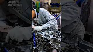Assembly Line Action: Workers Installing Engine Chains in a Car Factory!