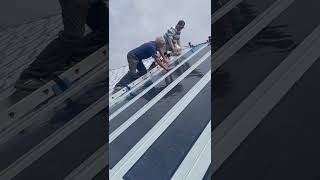 Installation of flexible lightweight Photonic Universe solar panels on a standing seam metal roof