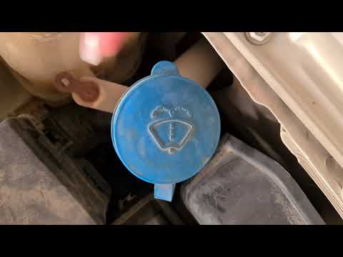She spilled half of the liquid out trying to pop the bubbles:) How to top up windscreen washer fluid