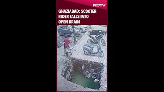 Scooter Rider Falls Into Open Drain Outside Gaur Green City Market In Ghaziabad