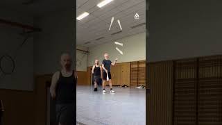 Duo Performs Juggling Trick With Five Clubs
