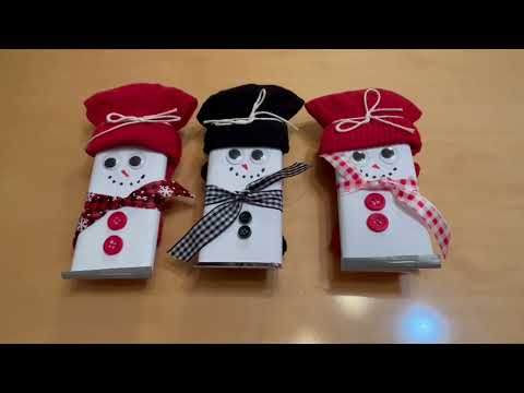 Make and give a snowman candy bar with a pair of mittens