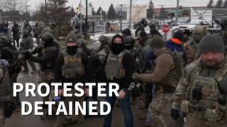 ICE officers detain protester as Minnesota demonstration turns tense