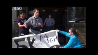 Jake breaks the banner at Marklund's Client Kick-off to the 5K