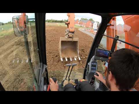 Excavator Hitachi 210 level top soil