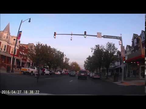 Bicycle rider in the middle of the street doing a wheelie