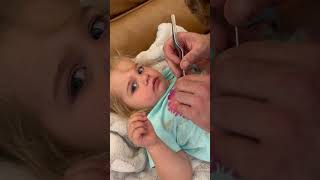Dad has to use tweezers to remove a pony bead from his daughter's nose!