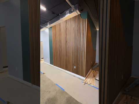 Custom walnut slat wall with Hidden door!🪵🔥 #customcarpentry #slatwall #woodstain #woodart #accent