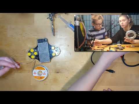 Polina and Anton soldering a Tetris kit
