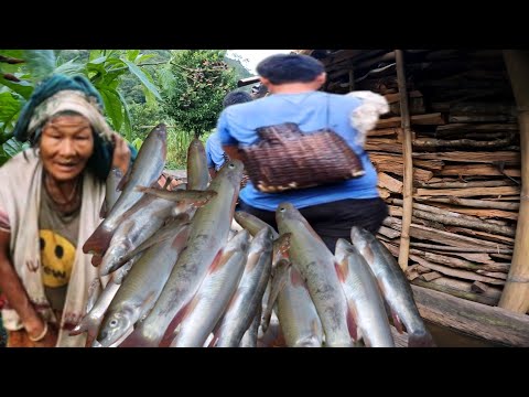 Happy family organic fish cooking recipe in the mid-eastern rural Region of Nepal