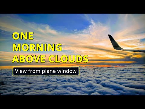 See through the plane Window. Plane fly above the clouds. Amazing view captured from the Window