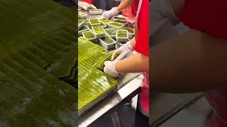 Gloved hands stack green layers sweet pandan rests neat