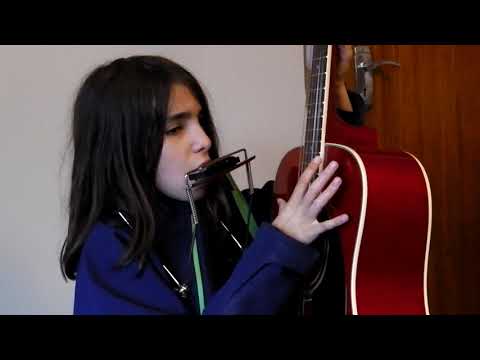 Hazel plays the harmonica