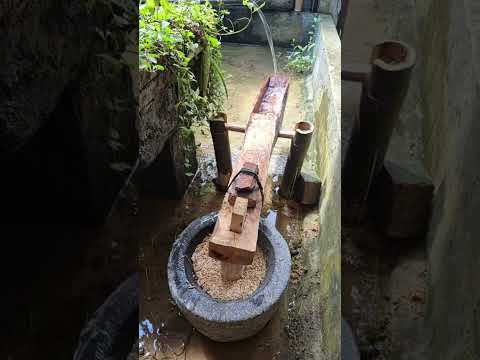 mortar to pound rice using water power