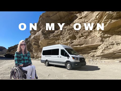 Wheelchair vanlifer explores a desert wash where 4x4 is recommended