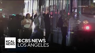 Chaos erupts overnight in downtown LA as mob vandalizes businesses, trains and a police car