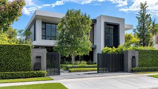 A Contemporary Fortress: Gated Modern Mansion Featuring Black Accents and Sharp Lines
