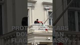 Protester tears down Iranian flag at embassy in London