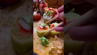 This SUSHI ROLL has shrimp, kani kama, masago, avocado, aioli, tempura crunch, wrapped in cucumber!
