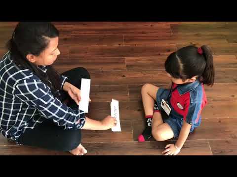 Jr.Kg child learning to read words