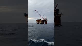 Exhausted But Determined: Pile Work Crew Awaiting Pickup After a Tough Day at Sea 🌊