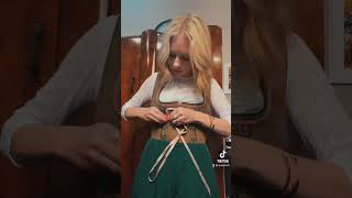 How to get ready for Oktoberfest in a Dirndl - Lacing up a dirndl with ribbon
